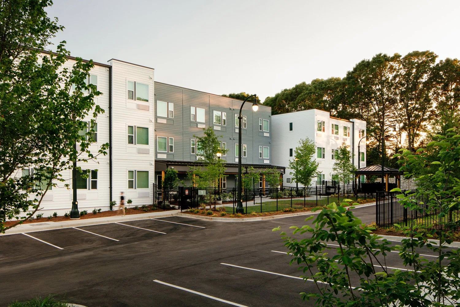 Three-story apartment buildings and landscaped courtyard at The Beacon at Cooper Street