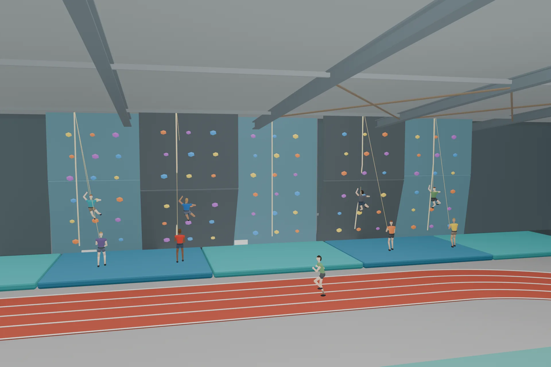 People using the indoor climbing wall beside the running track